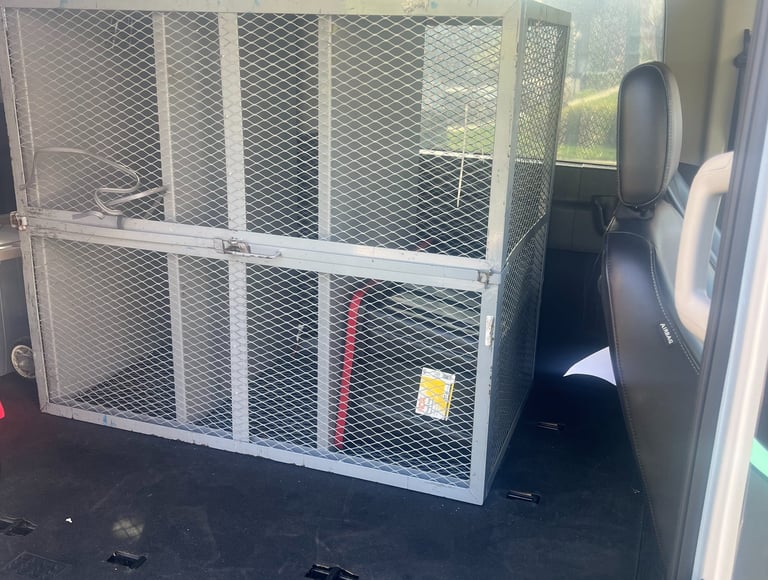 a van with a cage caged in to a cage