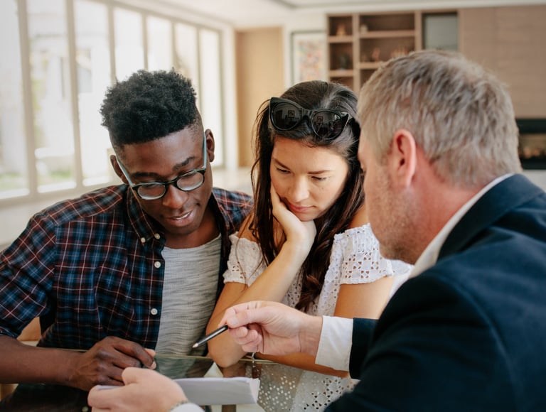 Professional real estate agent explaining interest rates to new home buyers