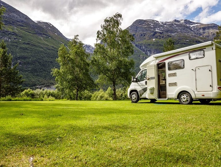 a camper van parked in a grassy field