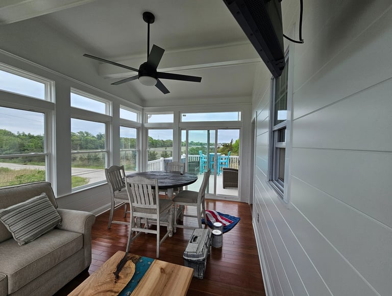 a white painted sun living room with a couch and a table