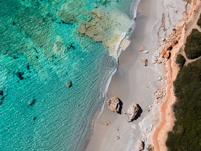 a beach with a beautiful water in the mediterrean sea