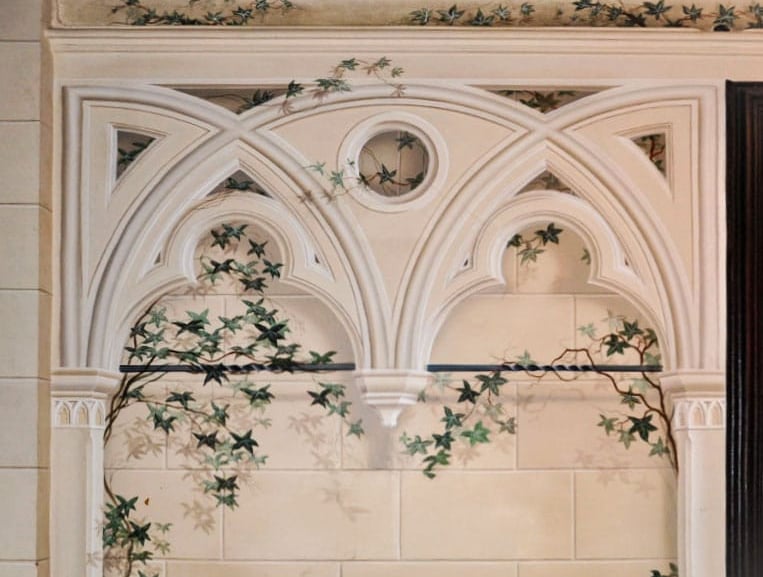 Painted trompe l'oeil gothic arch in a sandstone finish, complete with sandstone blocks in the background and ivy vines.