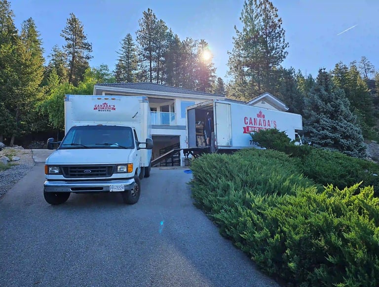 Canada’s Most Wanted Movers trucks loading at a hillside residential property in the Lower Mainland.