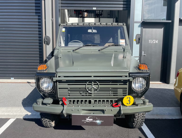 Front view of a matte green military-style Mercedes-Benz G-Wagon parked outside The Coating Lab