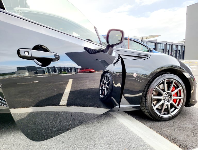 Side view of a black Toyota 86 sports car with paint corrected mirror-gloss finish by The Coating La