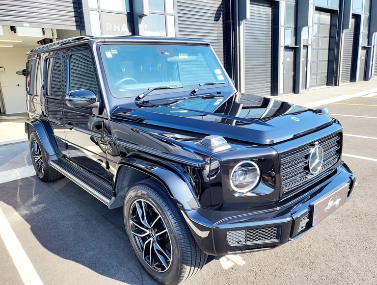 A sleek black ceramic coated Mercedes-Benz G-Class SUV parked outside The Coating Lab