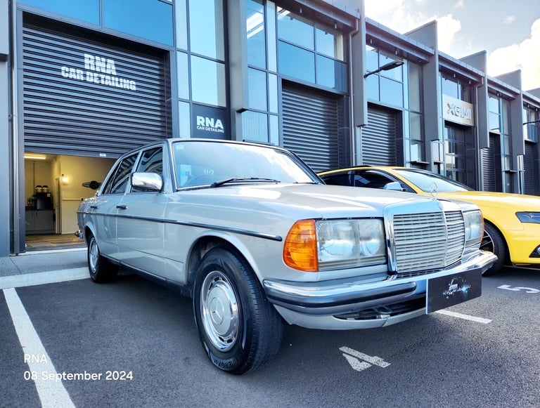 Classic silver Mercedes-Benz parked outside The Coating Lab for professional restoration services.
