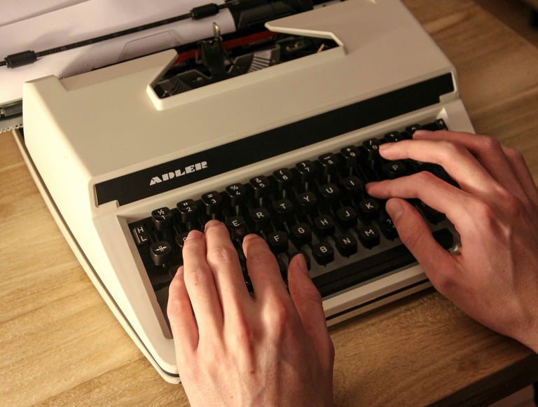 typewriter, two hands are typing