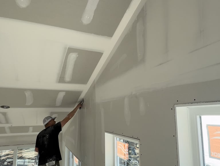 Cal Bakeberg, Owner of C&B Drywall, mudding a wall