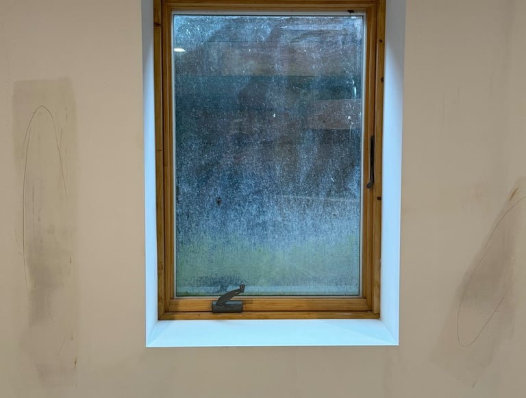 repaired drywall around window in residential basement