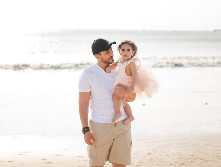 family photography Jimbaran Beach Bali mother father and child close moment by ocean