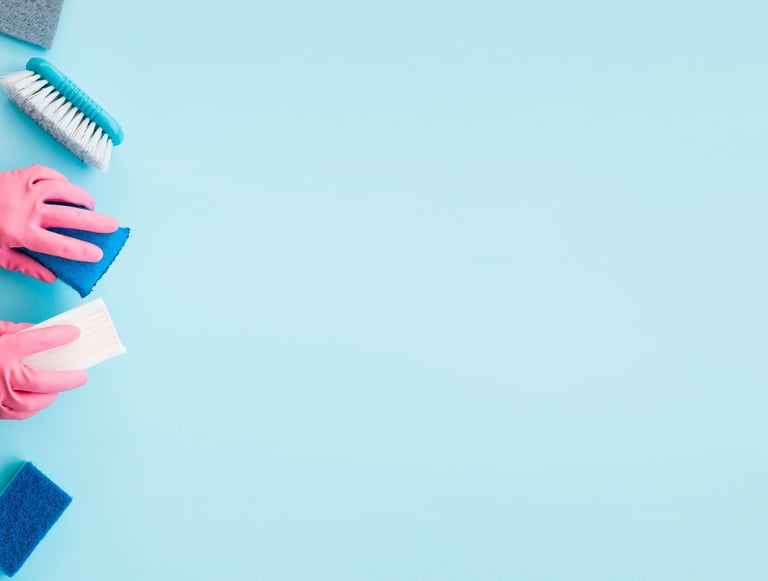 a person in gloves and gloves cleaning a blue surface