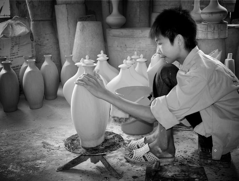 A young boy in Vietnam employed in jar-making through the lens of Peter Pickering