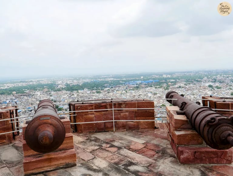 Aligned cannons on the ramparts of Mehrangarh Fort Jodhpur overlooking the panoramic Blue City view.