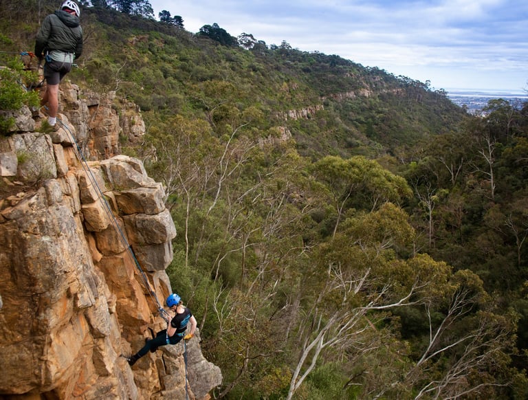 Participant abseiling down a sheer cliff during a Full day Rock Solid Adventure in South Australia