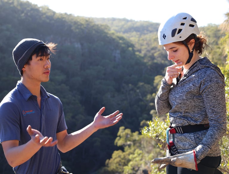 Participants learning rock climbing and abseiling skills in a hands on outdoor workshop.