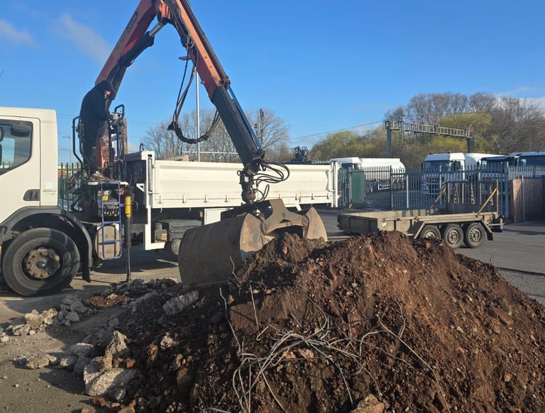 Construction site clearance using grab lorry in the West Midlands region
