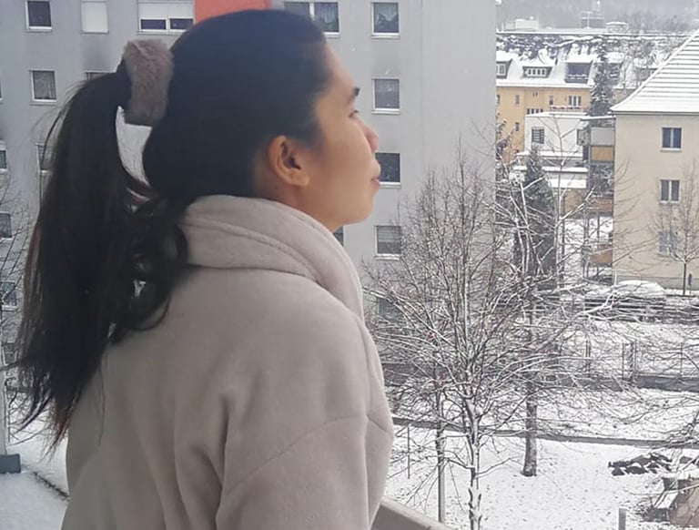 a woman in a coat and a coat over her head