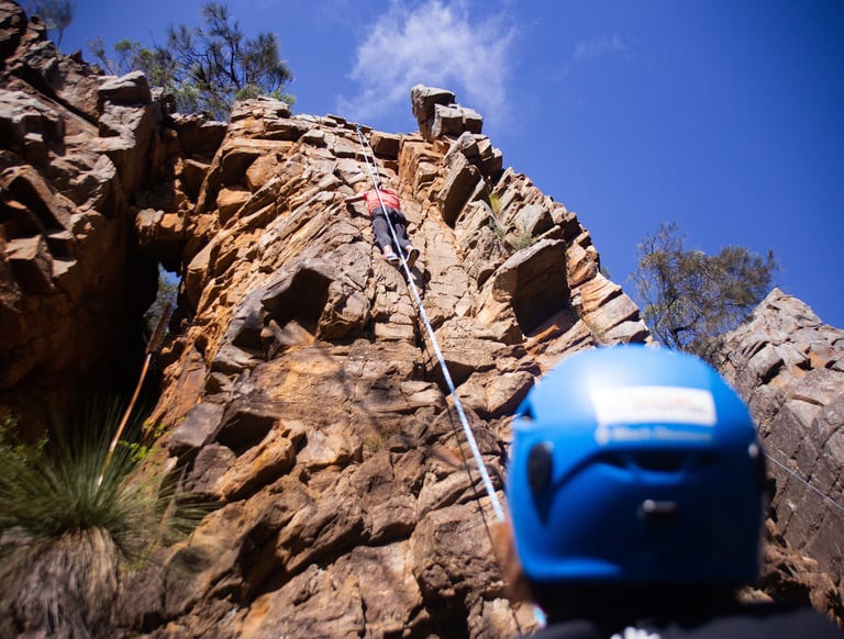 Group enjoying rock climbing on natural cliffs with expert instructors during a Full Day adventure