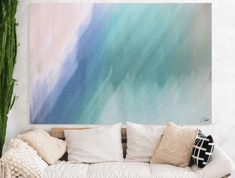 Abstract canvas prints on wall above couch with cushions