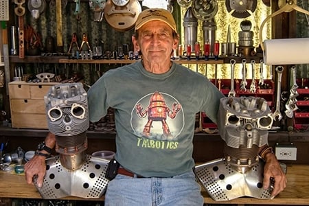 Talbotics t-shirt wearer with robot heads in the shop.