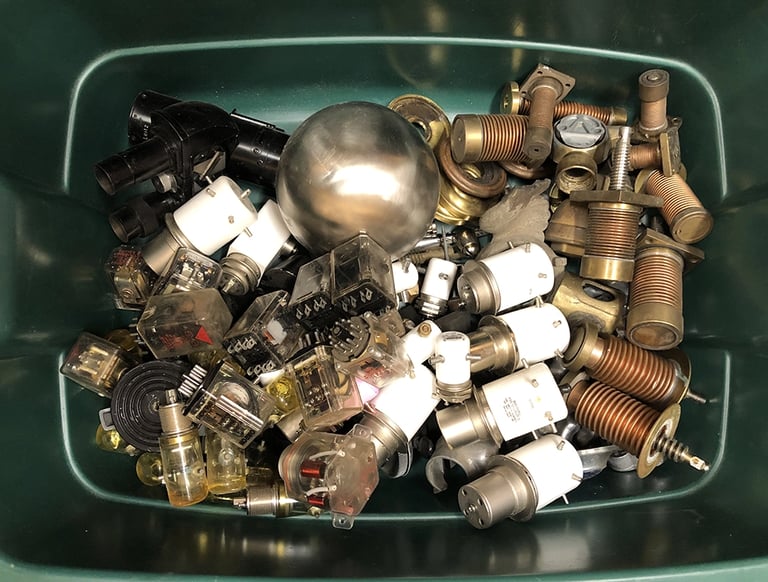 Metal parts in a sculptor's workshop bin, image 3.