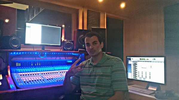 Rabzooz in a recording studio with a microphone and a computer