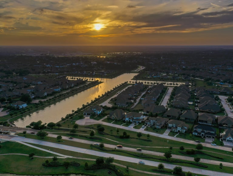 A sunset image of a man made lake in the form of a cross near Towne Lake Memorial Park, Cypress, TX