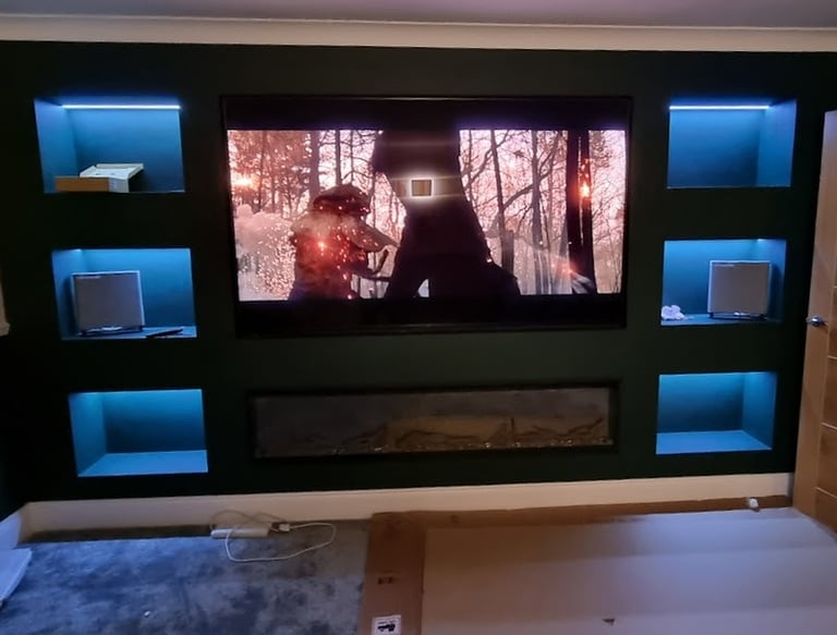 Sony Bravia 85" TV mounted on to a custom buint media wall with fire