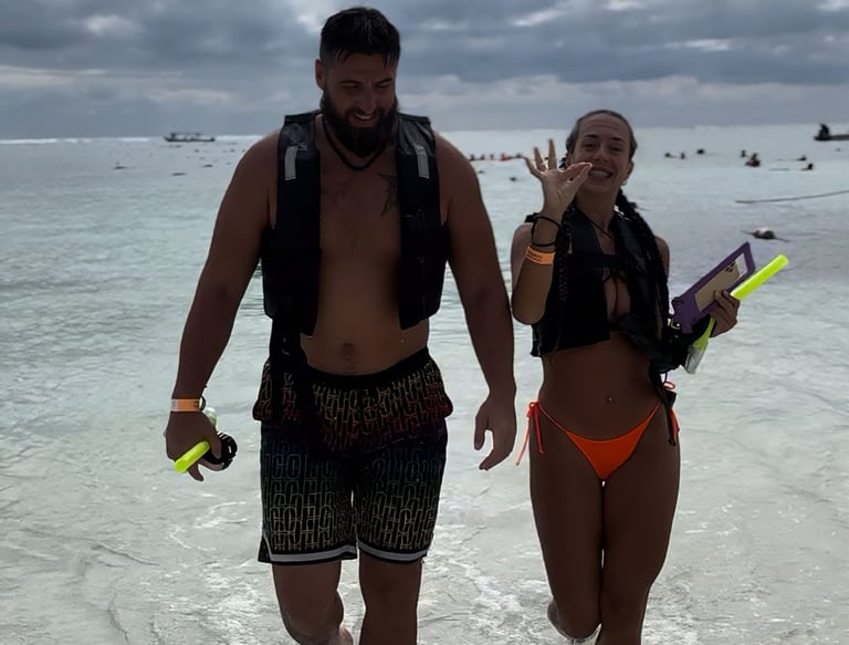 a man and woman walking in the water