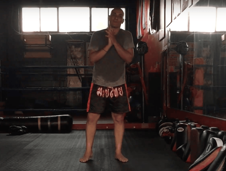 A man in a boxing ring with a punching bag!