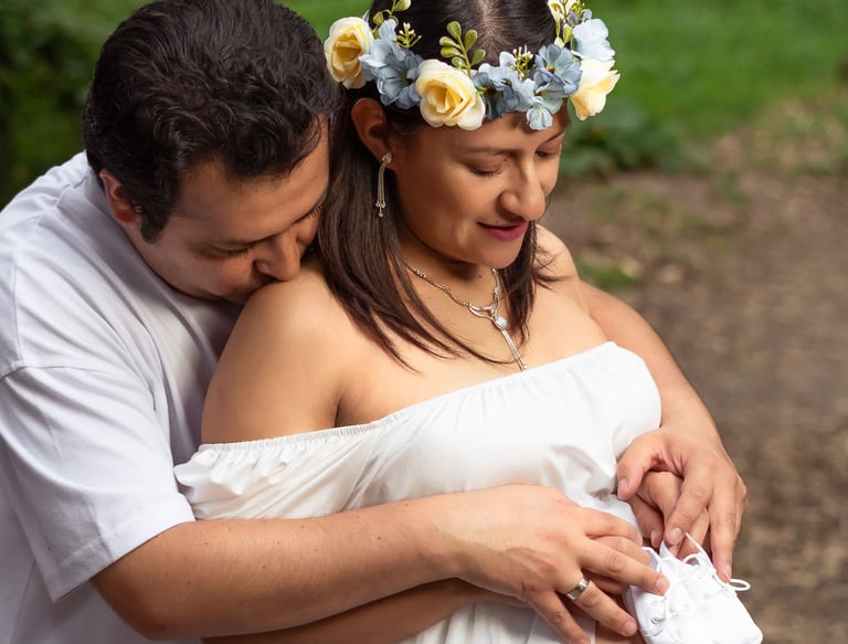 Foto profesional de maternidad embarazo en Quito Ecuador vientre descubierto con zapatos de bebé pareja de esposos