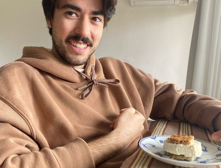 a man sitting at a table with a plate of food
