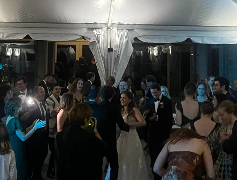 a group of people standing around a tent