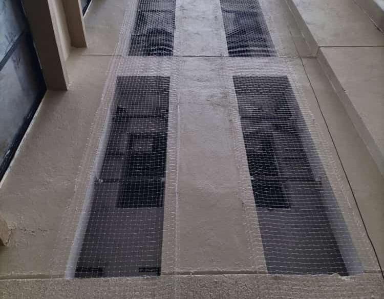 Technician carefully fitting a duct net in a residential building in Haralur, Bengaluru.