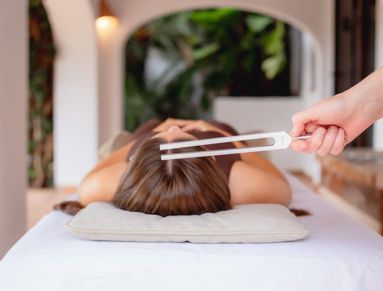 Sheila Doerfler activating client's Sun Star energy center with 174 Hz tuning fork