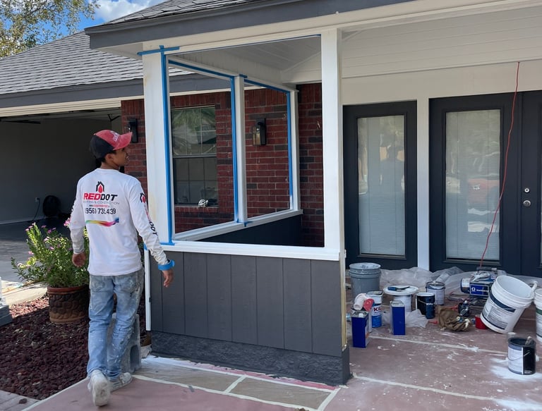 Professional painter prepping a residential front porch for a modern exterior house painting project.