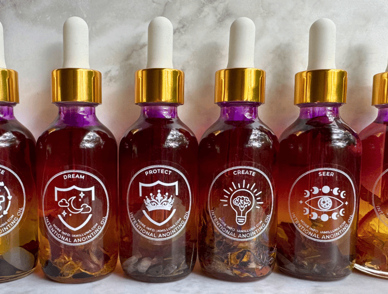 A row of beautiful fuschia to clear essential oil bottles with a gold screw on lid filled with herbs