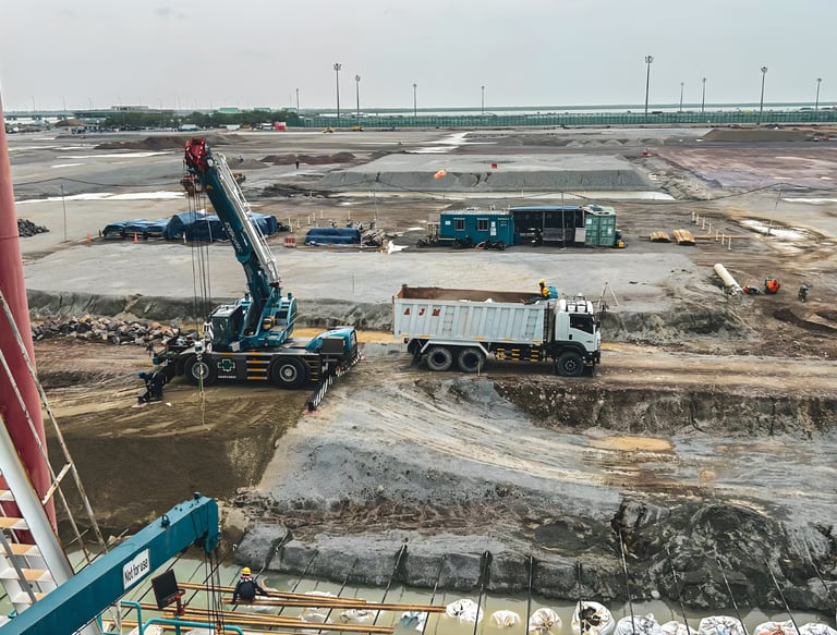 commercial sitework contractor loading materials on active infrastructure construction project Gulf 