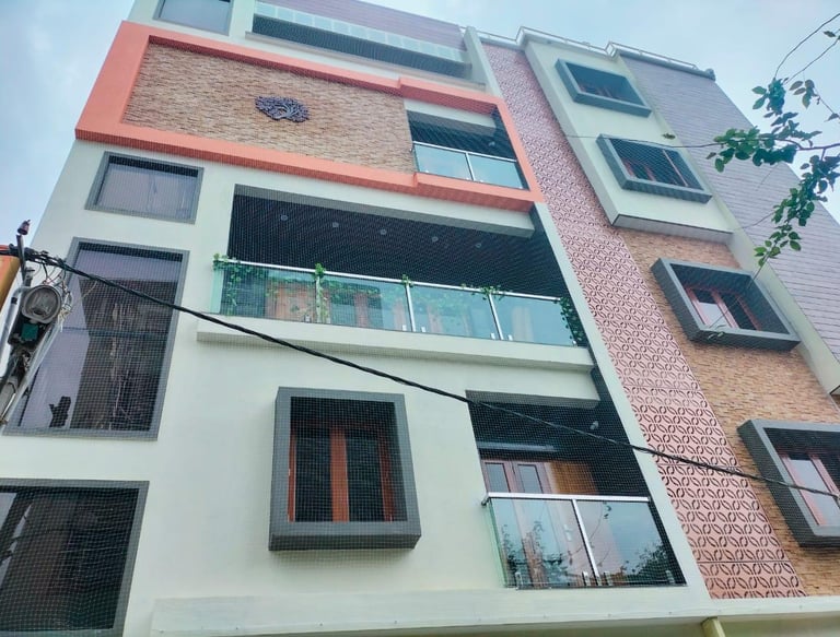 A happy family standing safely behind their balcony safety net installed by Arjilli Enterprises.