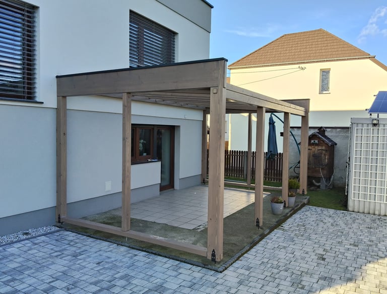a patio with a covered patio area with a pergolized roof