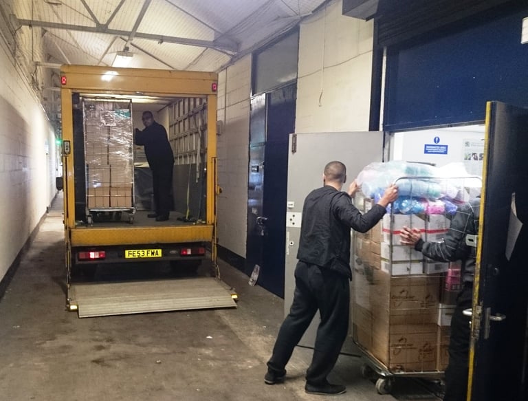 Man and Van hired by shopkeeper loading from their warehouse