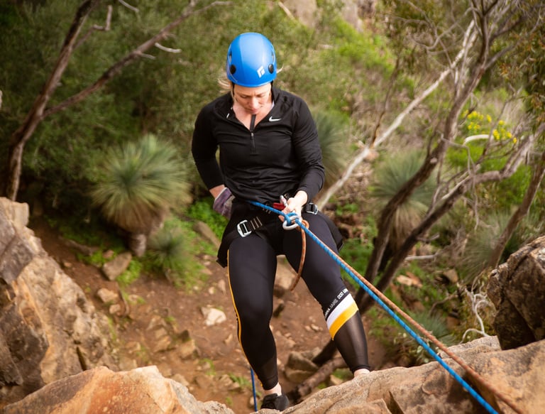 Abseiling down a cliff in South Australia, experiencing the thrill of safe, controlled descent.