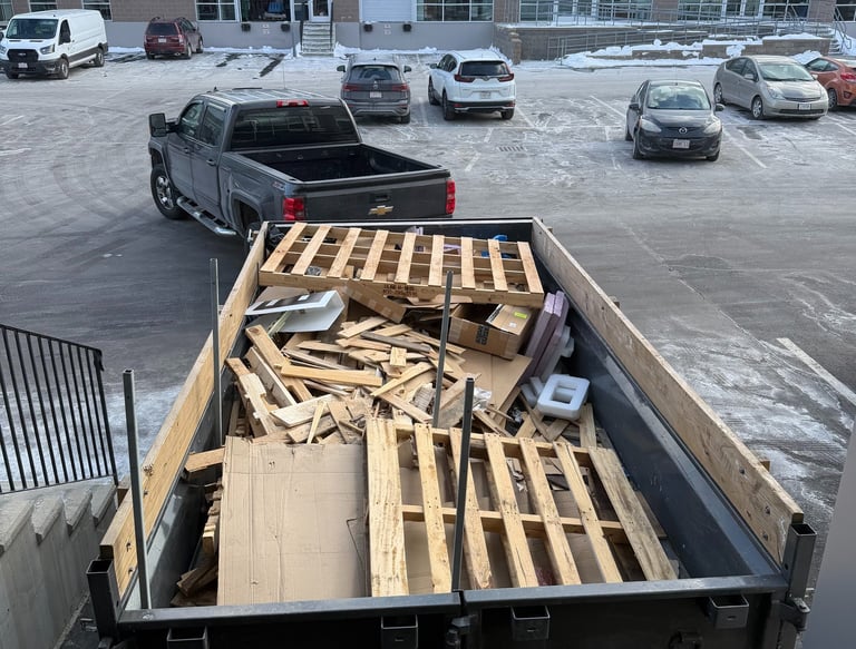 Construction debris and pallet hauling using a dump trailer in Belmont Massachusetts