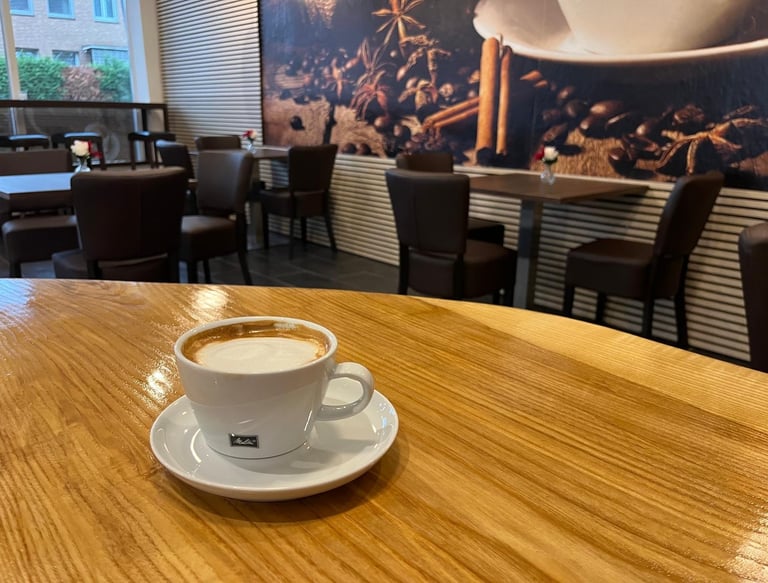 a cup of coffee on a table in a restaurant