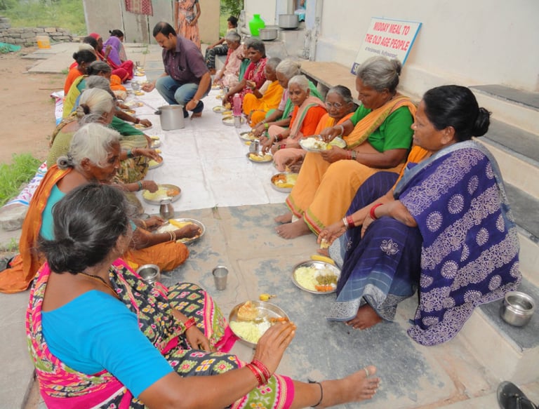 a group of people sitting around on floor with food