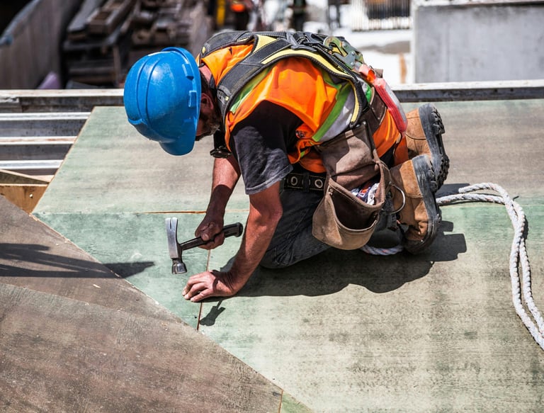 a construction worker is working on a roof