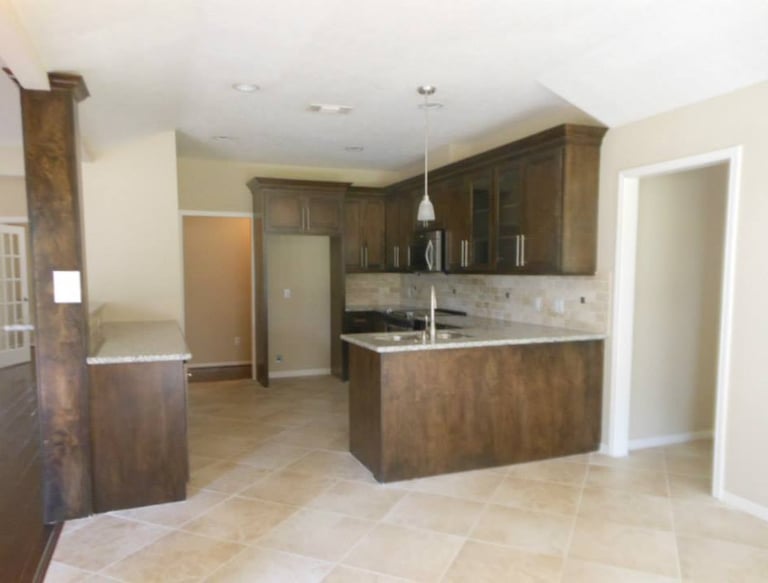 a kitchen with a large kitchen penensula