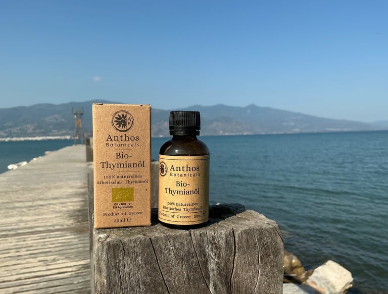 a bottle of thyme essential oil on a wooden table