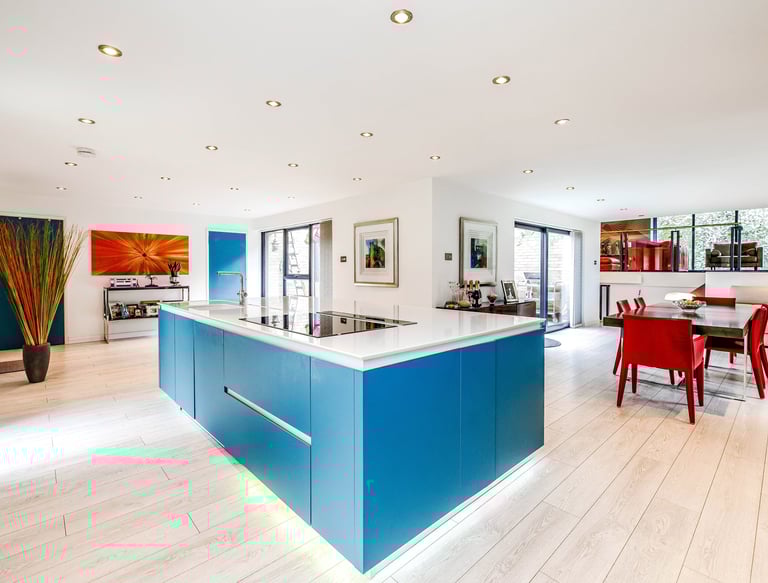 a kitchen with a blue counter top and a table with chairs